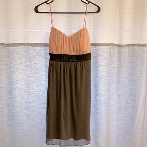 Cute pastel gray, with a pastel pink upper layer, dress. Black studs in the mid